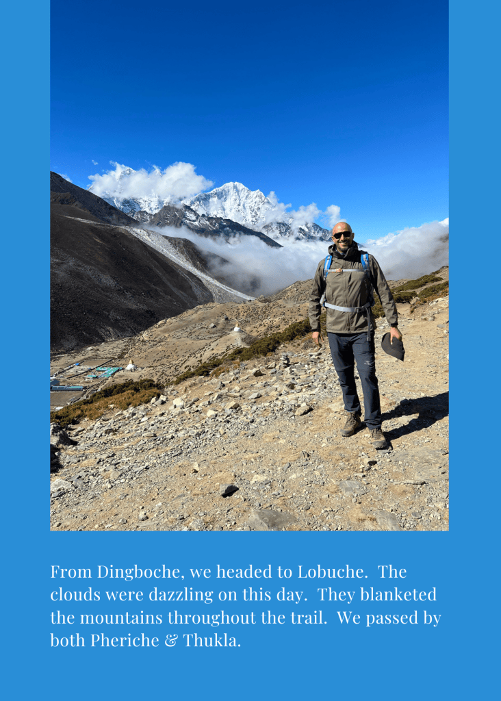 Mohamed Isa on the trail from Dingboche to Lobuche, with clouds below snow-capped peaks