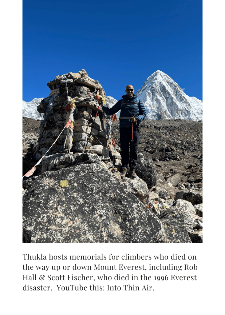 Mohamed Isa at the climbers' memorials at Thukla, with snow peaks behind