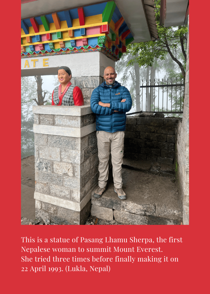 Mohamed Isa beside the statue of Pasang Lhamu Sherpa, the first Nepalese woman to summit Everest, in Lukla