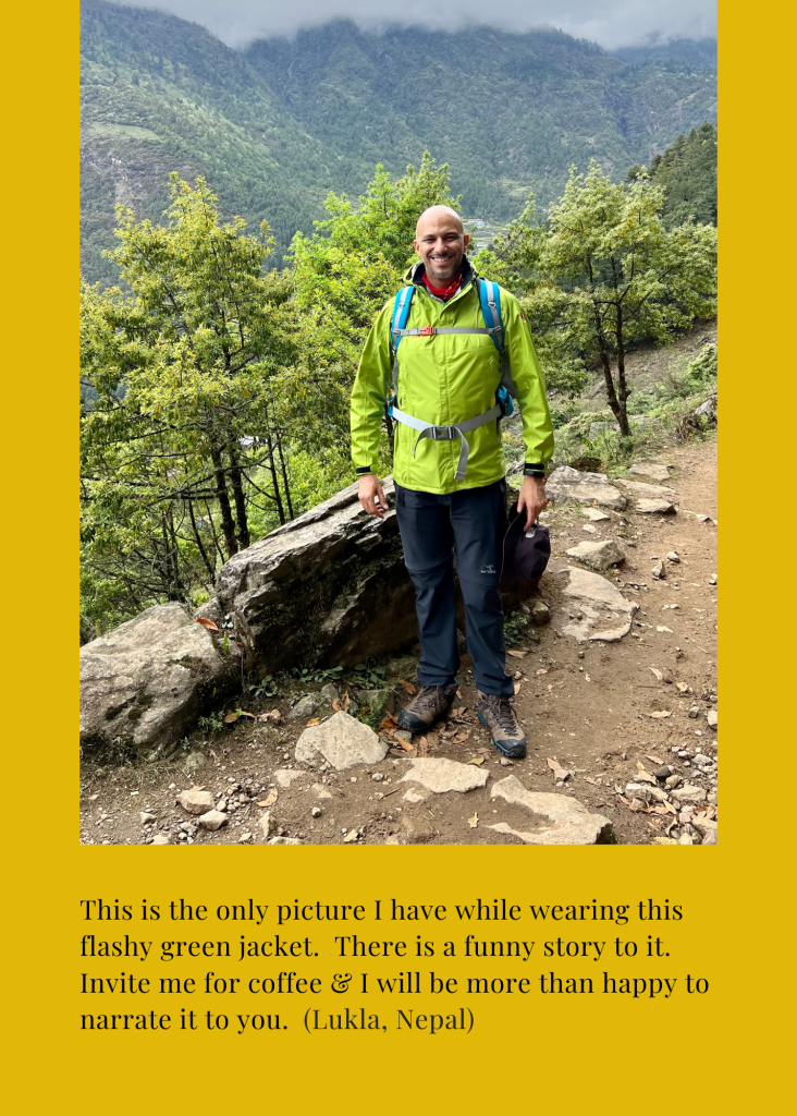 Mohamed Isa in a bright green jacket on the forest trail near Lukla
