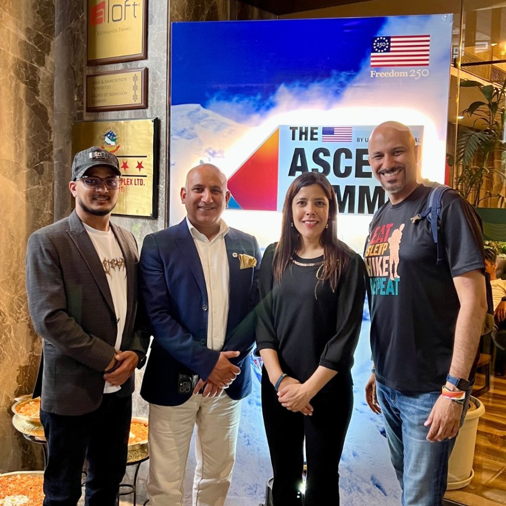 Mohamed Isa with Amrit, Deepak Raj Joshi and Archana in front of the Ascent Summit sign in Kathmandu