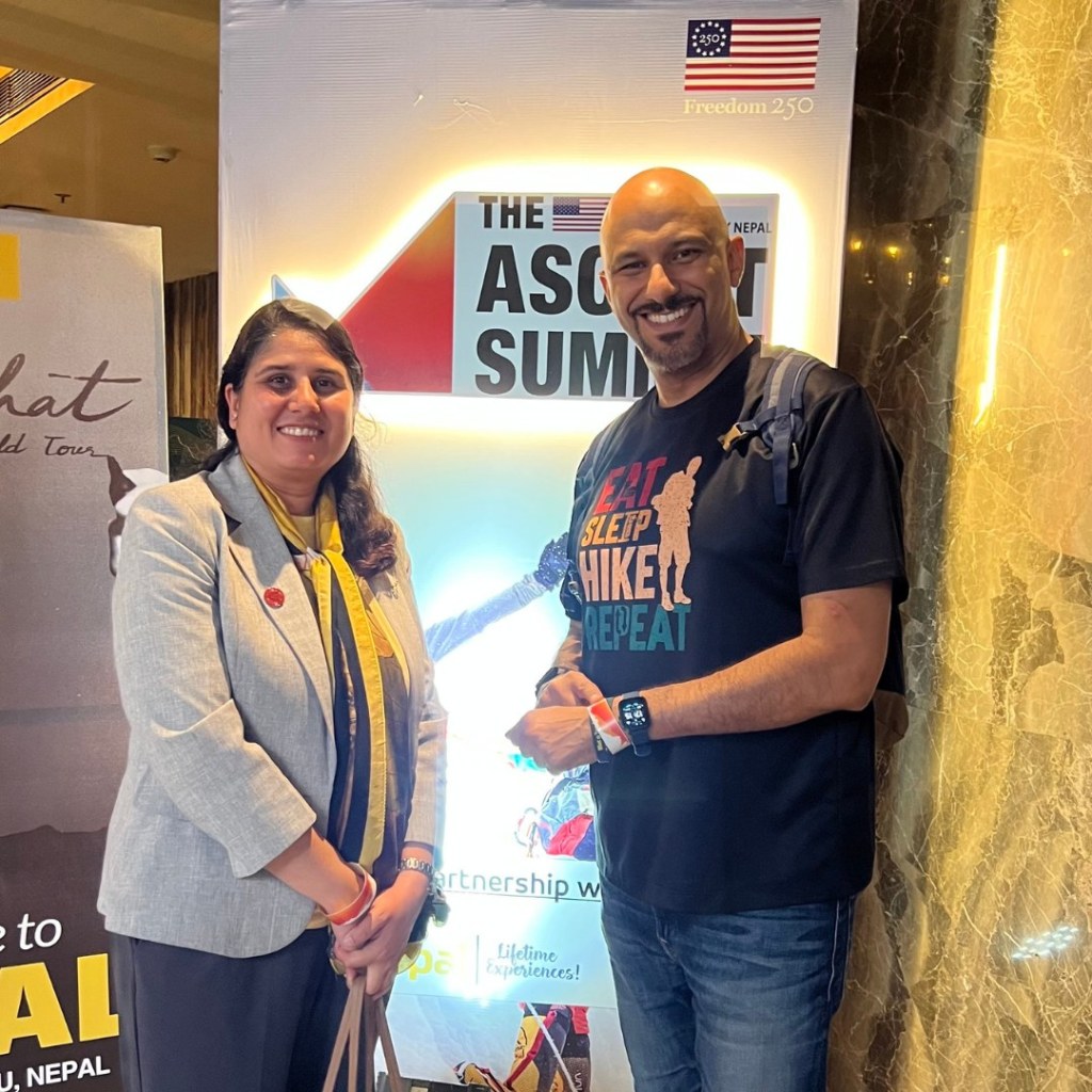Mohamed Isa with a fellow attendee in front of the Ascent Summit sign in Kathmandu