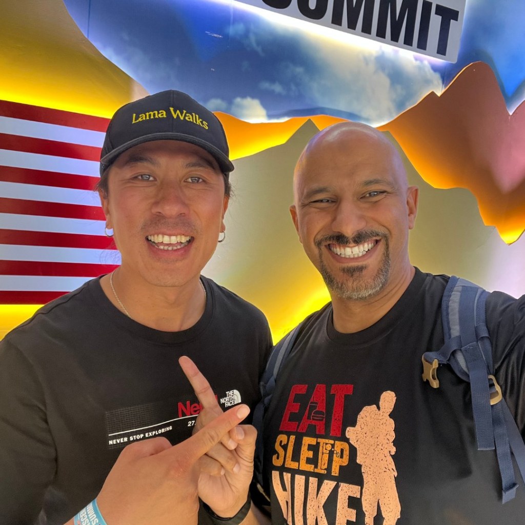 Mohamed Isa with a fellow attendee wearing a Lama Walks cap at the Ascent Summit